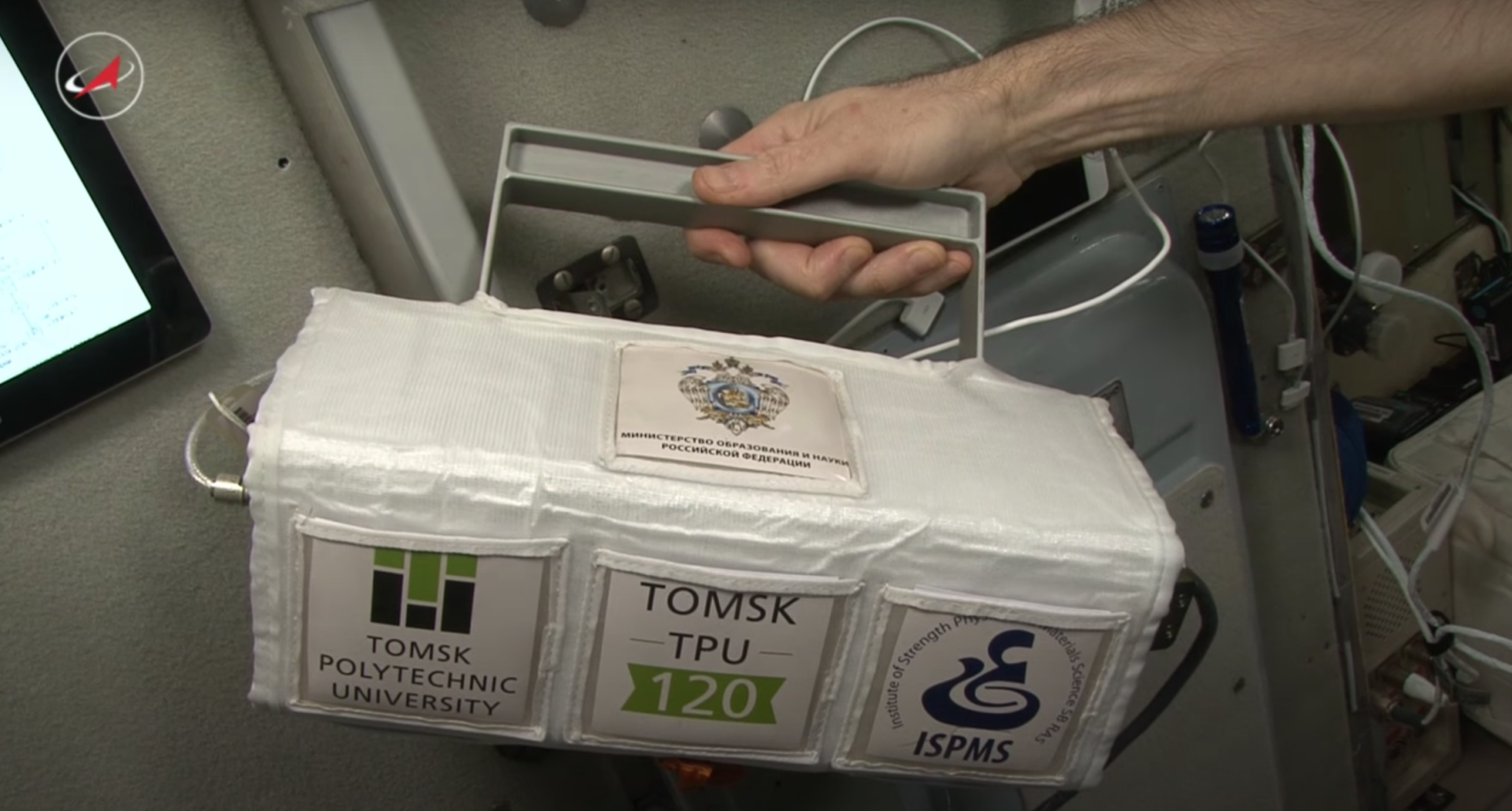 The Tomsk-TPU-120 microsatellite held by an astronaut on the International Space Station The Tomsk-TPU-120 microsatellite held by an astronaut on the International Space Station